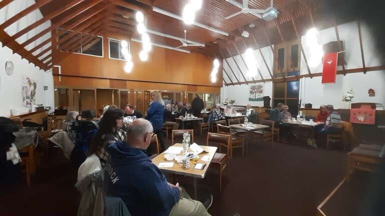 Scene at the Big Quiz, people sat at tables ready