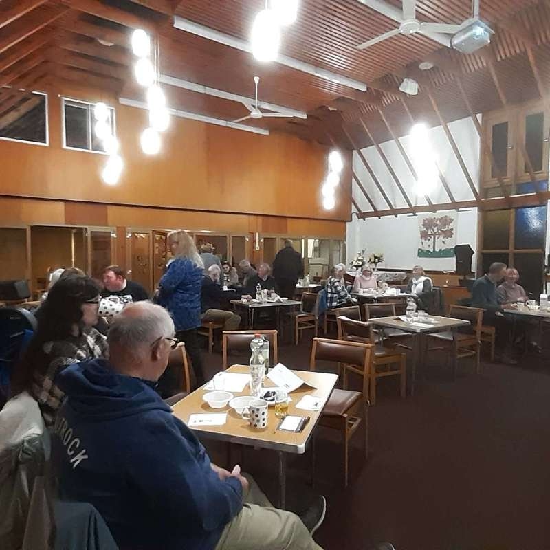 Scene at the Big Quiz, people sat at tables ready